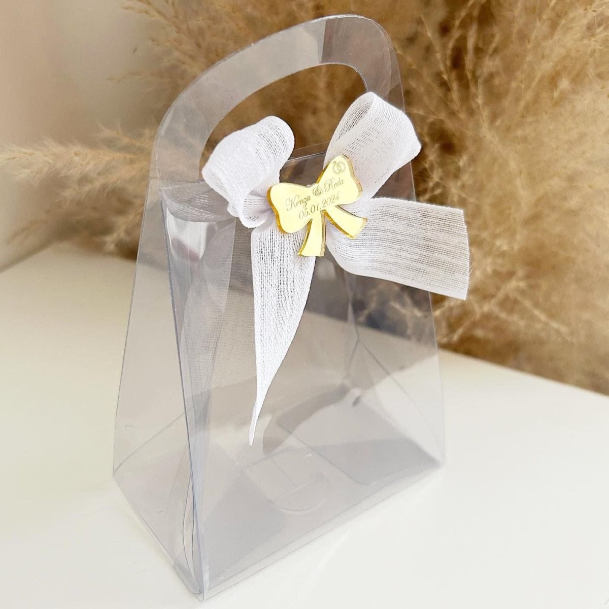 Sac Mona en plastique transparent avec nœud en lin et gravure plexiglas doré